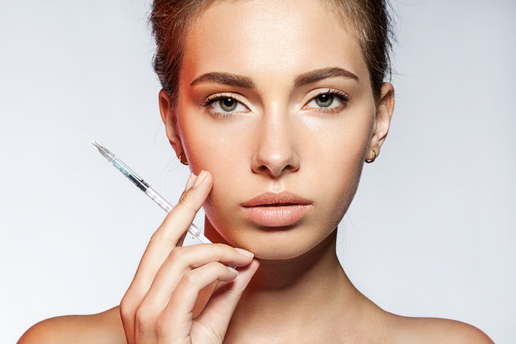 young woman with Botox injections in the syringe